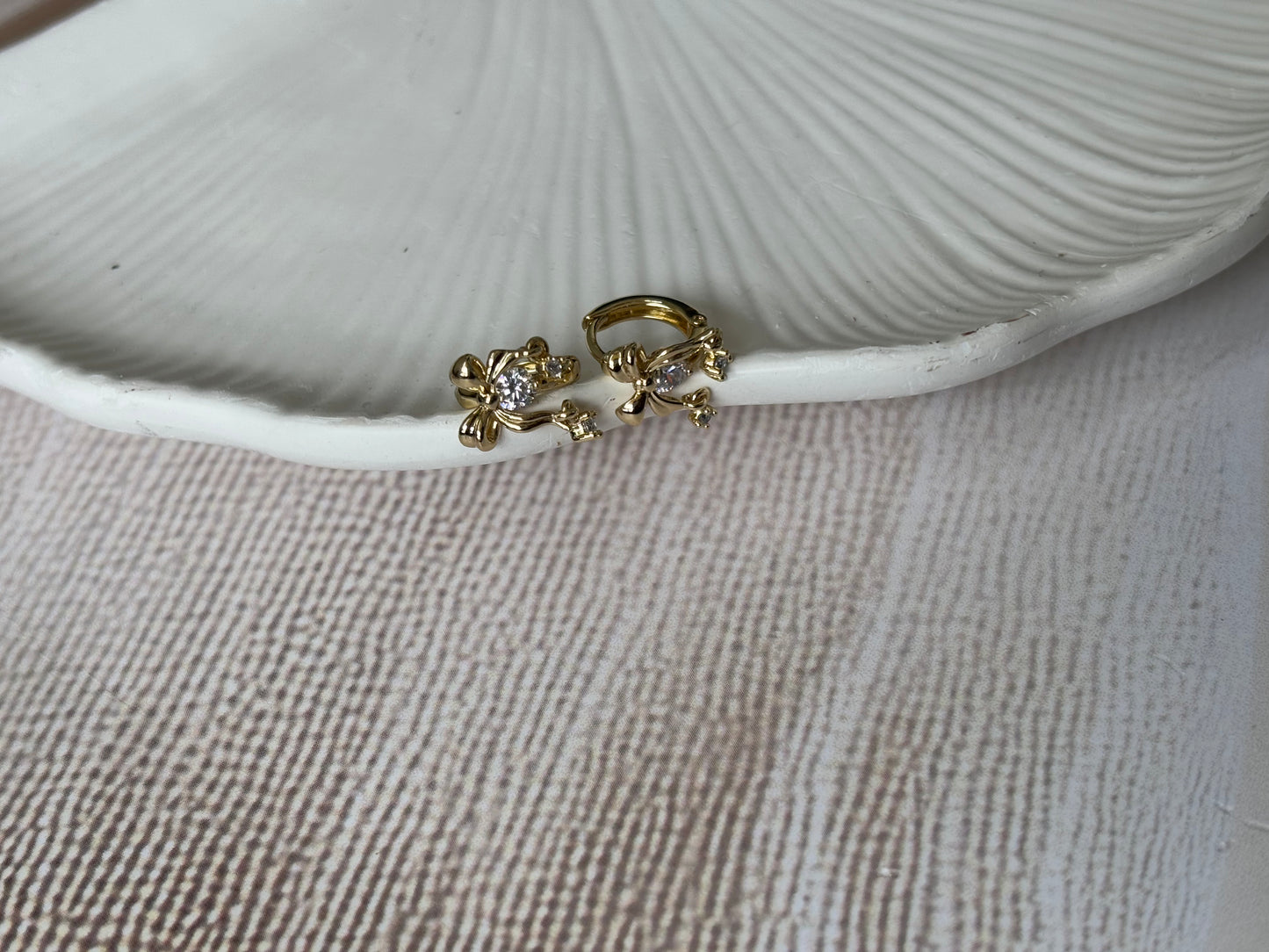 Bow huggie earrings with dangling AD stones