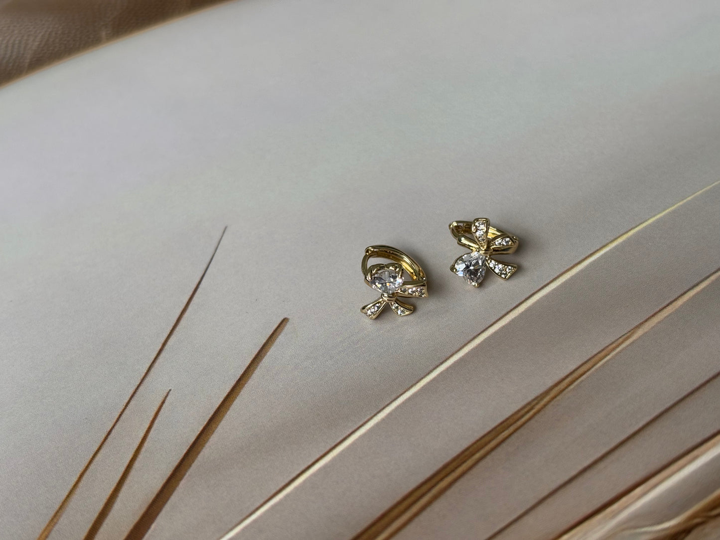 Bow huggie earrings