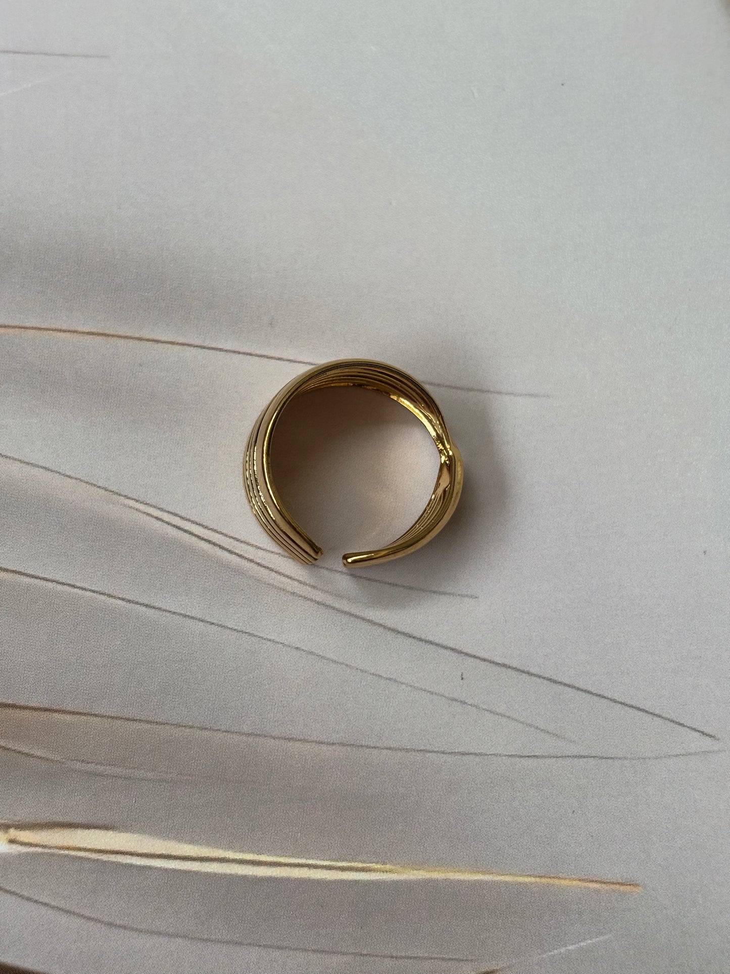 Broad criss cross ring