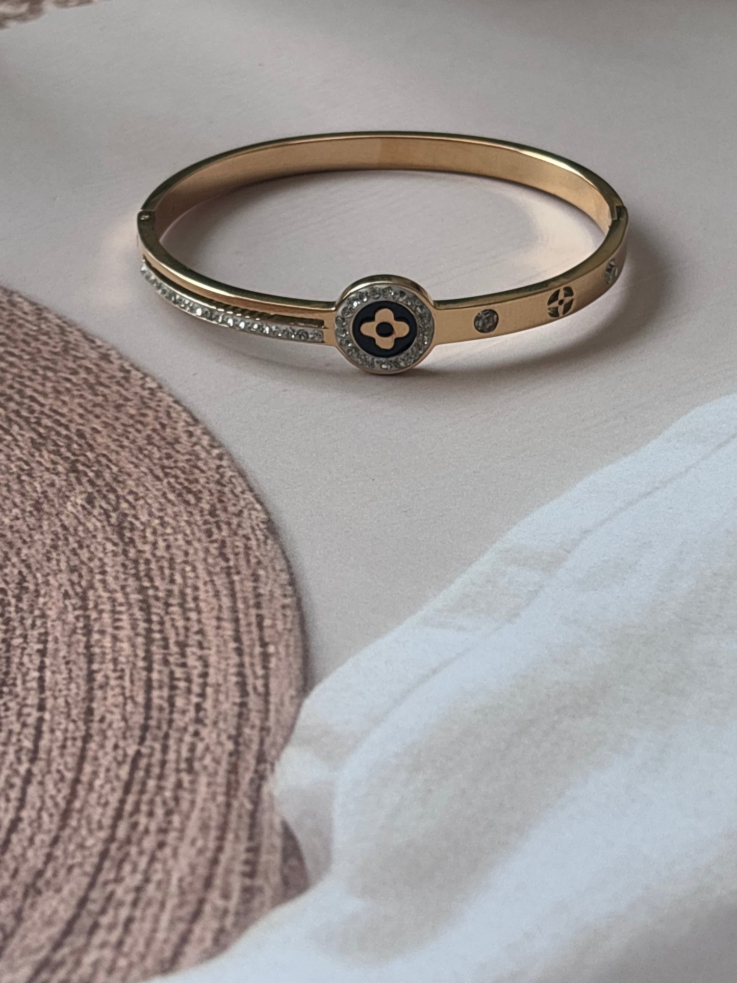 Black motif studded golden kada