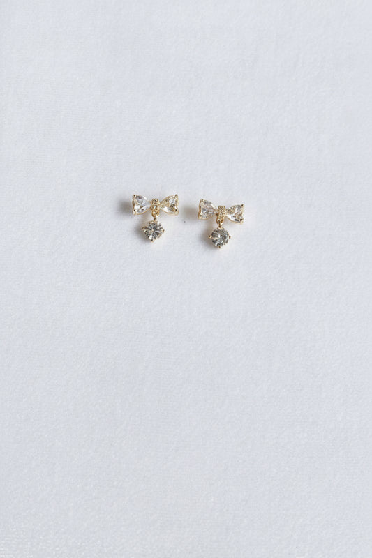 AD bow with dangling white stone studs