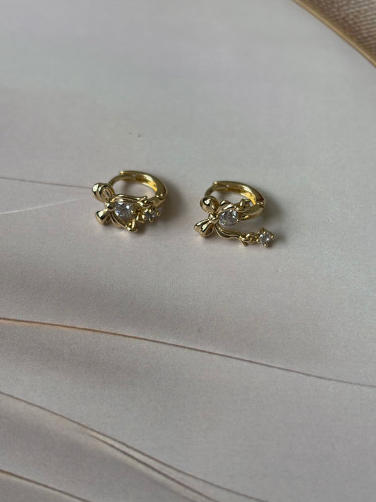 Bow huggie earrings with dangling AD stones