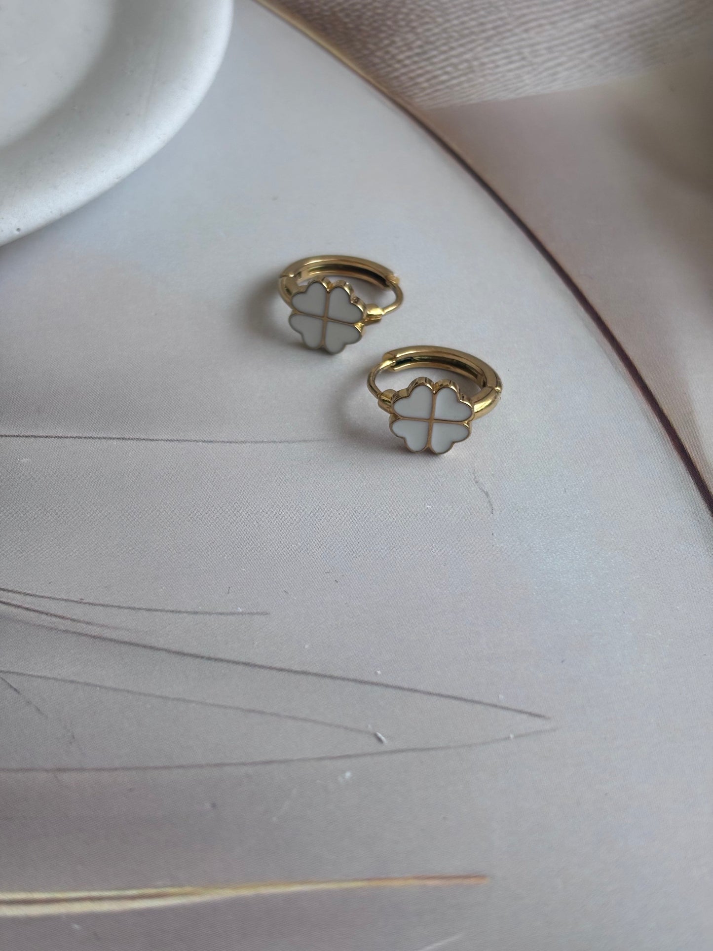 Clovery White Huggie Earrings