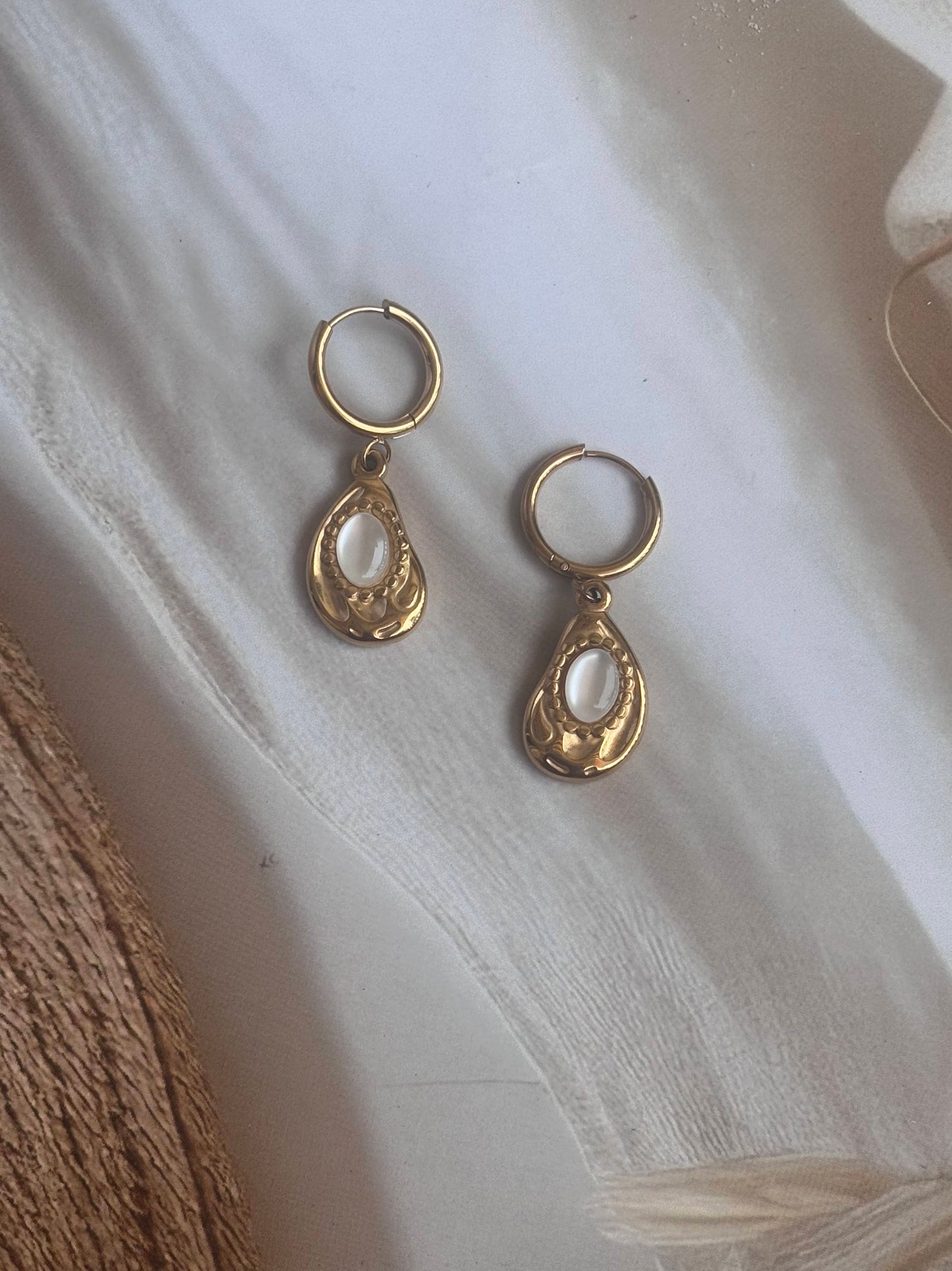 Golden white drop huggie dangler