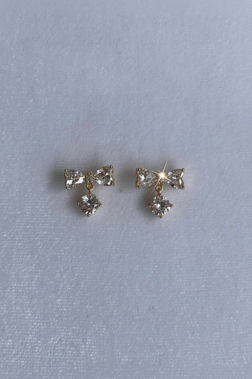 AD bow with dangling white stone studs