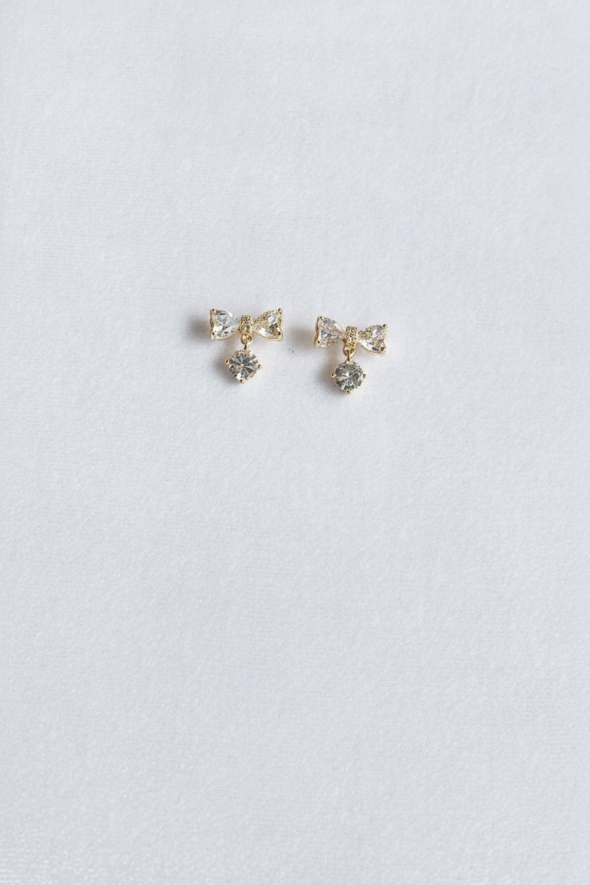 AD bow with dangling white stone studs
