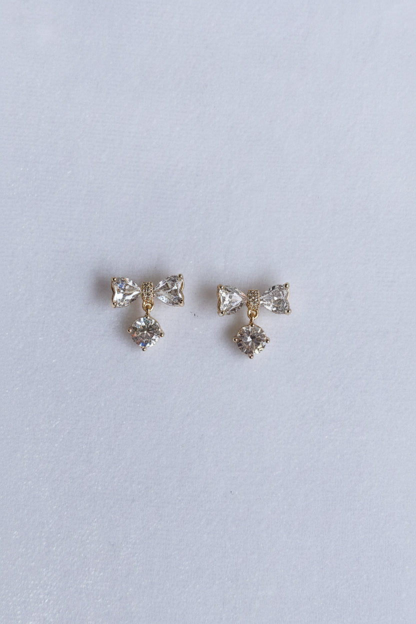 AD bow with dangling white stone studs