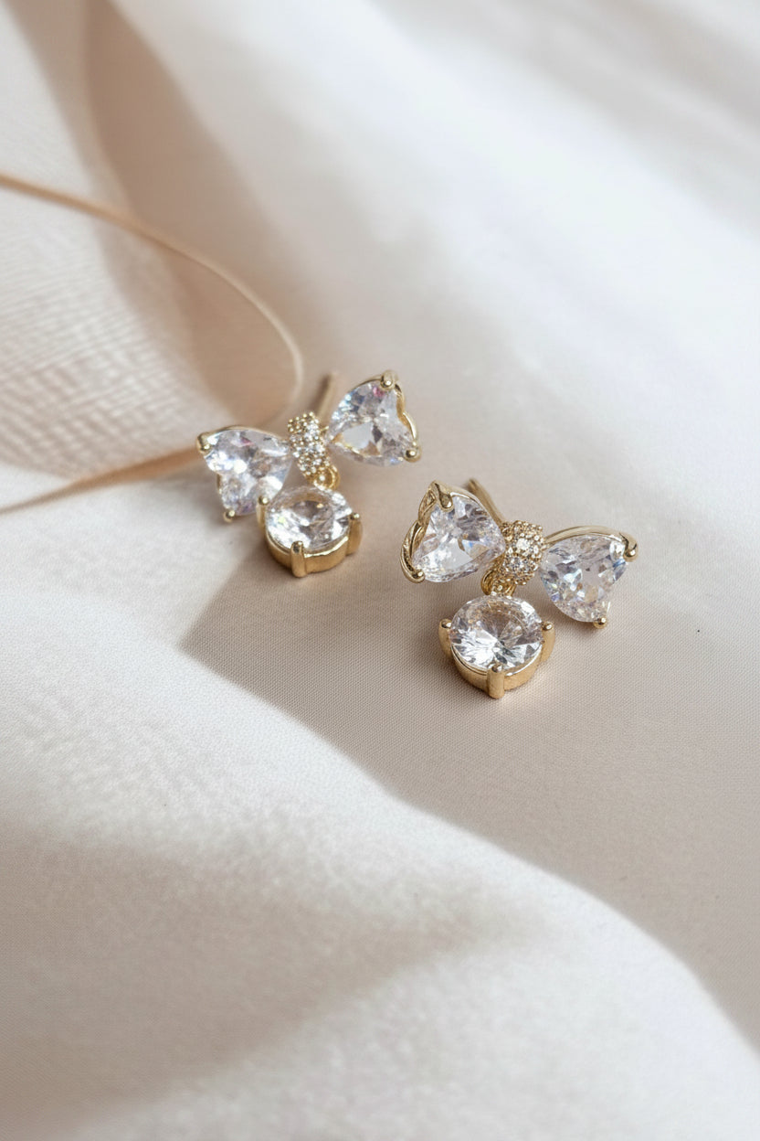 AD bow with dangling white stone studs